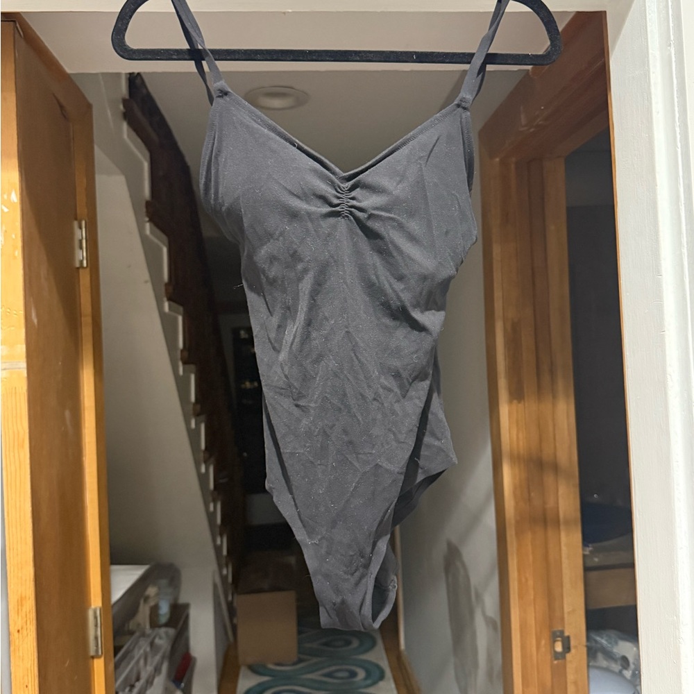 Super flattering Athleta black ruched bodysuit